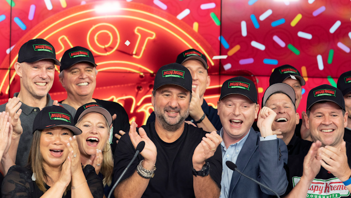 Krispy Kreme CEO Mike Tattersfield, center, applauds during the company's IPO at the Nasdaq Opening Bell on Thursday, July 1 in New York.