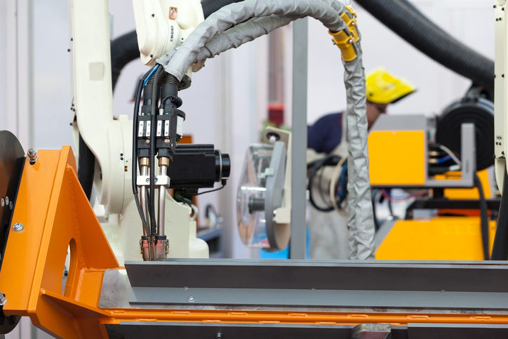 Industrial Welding Robot Arm, Blurred Welder In The Background 629761110 727x485 (1)