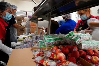 Los Angeles Unified School District food service workers from left, Tomoko Cho, Aldrin Agrabantes, April Thomas, and Marisel Dominguez, pre-package hundreds of free school lunches in plastic bags on Thursday, July 15, 2021, at the Liechty Middle School in Los Angeles. Flush with cash from an unexpected budget surplus, California is launching the nation's largest statewide universal free lunch program. When classrooms open for the fall term, every one of California's 6.2 million public school students will have the option to eat school meals for free, regardless of their family's income.