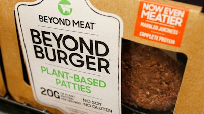 In this June 27, 2019 photo, a meatless burger patty called Beyond Burger made by Beyond Meat is displayed at a grocery store in Richmond, Va.