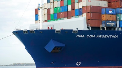 In this April 6, 2021 photo, crew members stand on the bow as the CMA CGM Argentina arrives at PortMiami, the largest container ship to call at a Florida port in Miami. Importers are contending with a perfect storm of supply trouble — rising prices, overwhelmed ports, a shortage of ships, trains, trucks — that is expected to last into 2022.