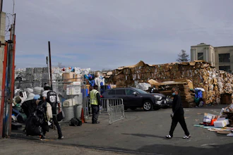 In this Feb. 18, 2021 photo, people walk inside a recycling location in Oakland, Calif.