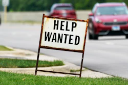 In this Tuesday, July 27, 2021, file photo, a help-wanted sign is displayed at a gas station in Mount Prospect, Ill. The gulf between record job openings and a lack of people taking those jobs is forcing Wall Street to reassess the pace of the economic recovery.