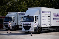 Instructor Graham Bolger directs learner truck driver Cadhene Lubin-Hewitt as he reverses at the National Driving Centre in Croydon, south London, Sept. 22, 2021.