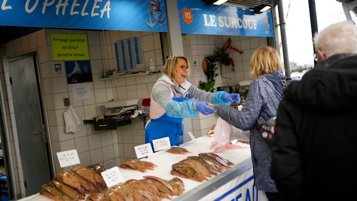 People buy fish at the market of the port of Boulogne-sur-Mer, northern France on Oct. 15.
