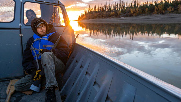 Michael Williams scans the shoreline for moose while traveling up the Yukon River on Tuesday, Sept. 14, 2021, near Stevens Village, Alaska. For the first time in memory, both king and chum salmon have dwindled to almost nothing and the state has banned salmon fishing on the Yukon. The remote communities that dot the river and live off its bounty are desperate and doubling down on moose and caribou hunts in the waning days of fall.