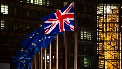 In this Dec. 9, 2020 file photo, the Union Flag and European Union flags flap in the wind prior a meeting between European Commission President Ursula von der Leyen and British Prime Minister Boris Johnson at EU headquarters in Brussels.