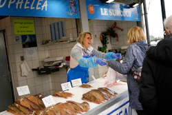 People buy fish at the market of the port of Boulogne-sur-Mer, northern France on Oct. 15.