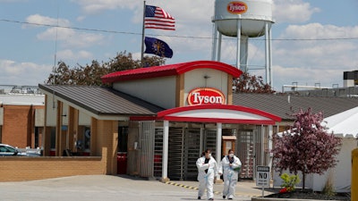 In this May 7, 2020 photo, workers leave the Tyson Foods pork processing plant in Logansport, Ind.