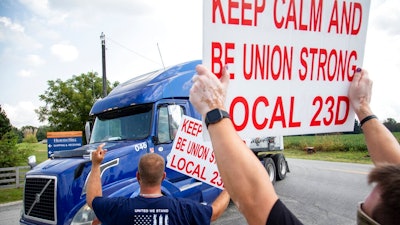 In this Sept. 13, 2021 file photo, members of Local 23D Union picket in front of Heaven Hill Distillery in Bardstown, Ky. Workers at one of the world’s largest bourbon producers, are scheduled to vote on a new contract on Saturday, Oct. 23, six weeks after walking out. The company announced a tentative contract agreement with the union representing striking workers on Friday.