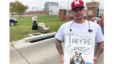 Michael Shlee, a bulk unloader at a Kellogg's cereal plant, pickets outside the facility's main entrance on Wednesday, Oct. 6, 2021, in Omaha, Neb. Workers have gone on strike after a breakdown in contract talks with company management.