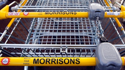 In this Thursday, Dec. 4, 2008 file photo, supermarket trolleys are seen outside a Morrisons supermarket in London. An American private equity group saw off a rival to narrowly win the battle to buy British supermarket chain Morrisons following a dramatic auction for the company. Britain's Takeover Panel said Saturday that New York-based Clayton, Dubilier & Rice (CD&R) offered 287 pence for each Morrisons share, just a penny more than the offer from Fortress, which is backed by Japanese bank Softbank.