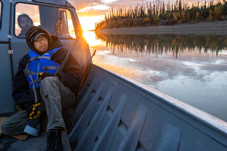 Michael Williams scans the shoreline for moose while traveling up the Yukon River on Tuesday, Sept. 14, 2021, near Stevens Village, Alaska. For the first time in memory, both king and chum salmon have dwindled to almost nothing and the state has banned salmon fishing on the Yukon. The remote communities that dot the river and live off its bounty are desperate and doubling down on moose and caribou hunts in the waning days of fall.