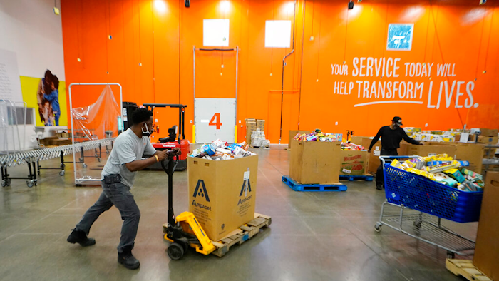 Volunteer group leader Bruce Beecham works to sort food items in the Atlanta Food Bank's Hunger Action Center on Sept. 22, 2021 in College Park, Ga.