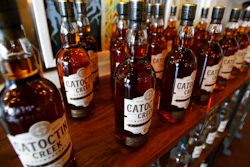In this June 20, 2018 photo, Catoctin Creek Distillery whiskey is on display in a tasting room in Purcellville, Va.