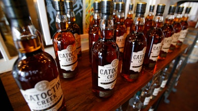 In this June 20, 2018 photo, Catoctin Creek Distillery whiskey is on display in a tasting room in Purcellville, Va.