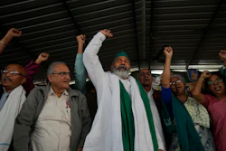 Farmer leader Rakesh Tikait , center, and others raise slogans during a rally at Ghazipur, on the outskirts of New Delhi, India on Nov. 26, 2021.