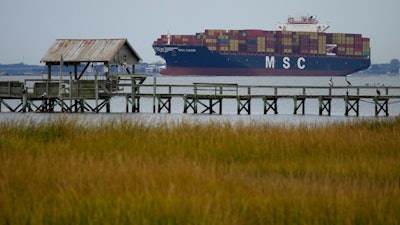 The MSC Naomi container ship sails out from from the port of Charleston, S.C.,Thursday, Oct. 28, 2021. Hampered by rising COVID-19 cases and persistent supply shortages, the U.S. economy slowed sharply to a 2% annual growth rate in the July-September period, the weakest quarterly expansion since the recovery from the pandemic recession began last year.