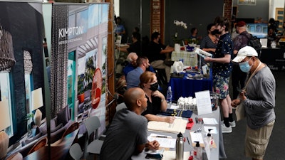 In this Sept. 22, 2021, file photo, prospective employers and job seekers interact during a job fair in the West Hollywood section of Los Angeles. California has been averaging more than 100,000 new jobs each month since February. New data released Friday, Oct. 22, 2021, by the U.S. Bureau of Labor Statistics shows California is now tied with Nevada for the highest unemployment rate in the country at 7.5%.