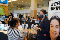 Marriott human resources recruiter Mariela Cuevas, left, talks to Lisbet Oliveros, during a job fair at Hard Rock Stadium, Friday, Sept. 3, 2021, in Miami Gardens, Fla. The number of Americans applying for unemployment benefits fell to a new pandemic low 267,000 last week.
