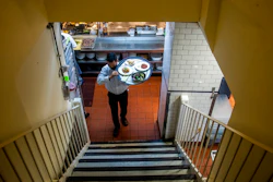Muhammad Rahman delivers orders at Gotham restaurant on Dec. 14, 2021 in New York.