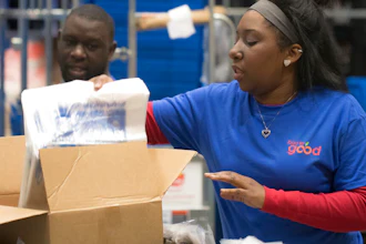 In this 2018 photo provided by Holt Haynsworth, Portia Thomas packs boxes at the Food For Good Warehouse in Austin, Texas.