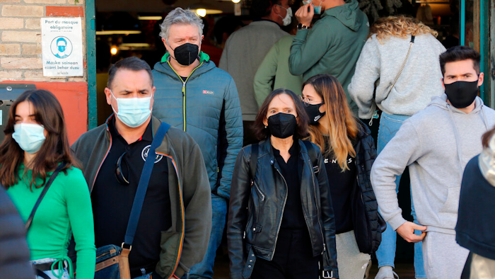 People wearing face mask walk on the street in Saint Jean de Luz, southwestern France on Dec.30, 2021.