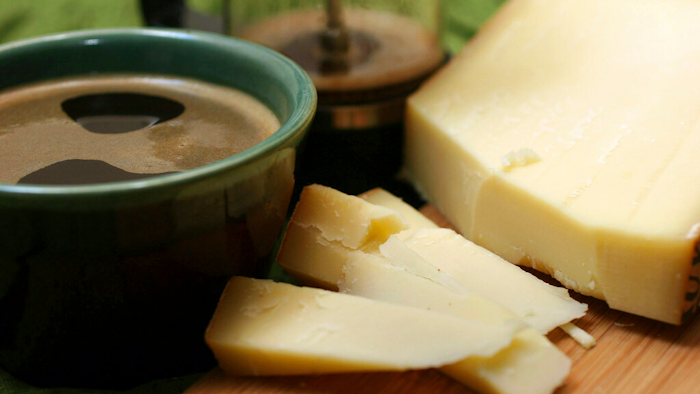 This Feb. 15, 2007 file photo shows a Gruyere cheese with a cup of Italian roast coffee.