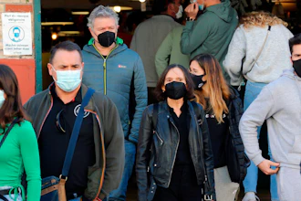 People wearing face mask walk on the street in Saint Jean de Luz, southwestern France on Dec.30, 2021.