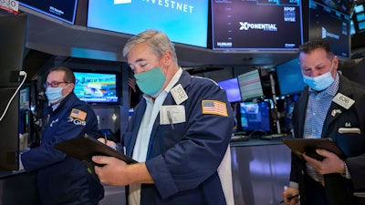 Traders Edward McCarthy, center, and Edward Curran, right, on the floor of the New York Stock Exchange, Jan. 10, 2022.