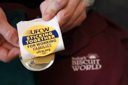 Former Tudor's Biscuit World employee Jennifer Patton hold stickers displaying the logo of the United Food & Commercial Workers Local 400 union at her coworker's home in Elkview, W.Va., on Jan. 20, 2022. Patton said she was retaliated against and fired by management after she joined efforts to unionize the restaurant. Employees at the Elkview, W.Va., restaurant have already case ballots to decide whether or not they want to create a union. The votes will be read Tuesday.