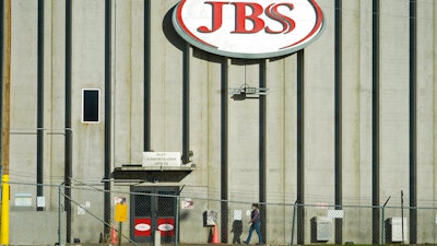 A worker heads into the JBS meatpacking plant on Oct. 12, 2020 in Greeley, CO.