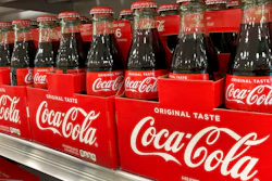 Bottles of Coca-Cola are stacked on a shelf in a grocery store on Dec. 15, 2021 in Surfside, Fla.