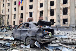 In this handout photo released by Ukrainian Emergency Service, a burnt car is seen in front of a damaged City Hall building, in Kharkiv, Ukraine on March 1, 2022.