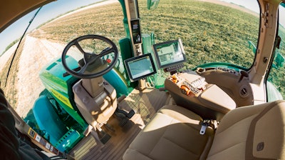 An autonomous John Deere tractor plowing a field, Blue Earth, Minn.