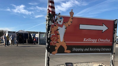 Striking Kellogg's workers stand outside the company's cereal plant in Omaha, Neb., on Dec. 2, 2021. Several hundred workers at a Kellogg's plant that makes Cheez-Its won a new contract, Wednesday, March 30, 2022, that delivers more than 15% wage increases over three years after 1,400 workers at the company's cereal plants went on strike for nearly three months last fall.