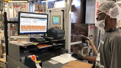 A Pod Pack employee checks DELMIAworks’ ShopData module that gives him a visual of the performance on the plant floor.