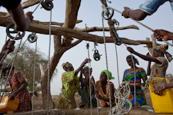 Women crowd a well in Kiral, Senegal, May 1, 2012.