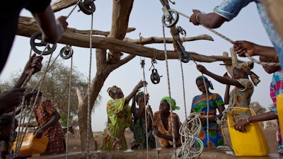 Women crowd a well in Kiral, Senegal, May 1, 2012.