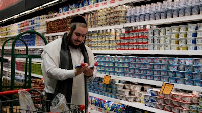 Moshe Werzberger shops for Passover food and other groceries at a kosher supermarket, Williamsburg, Brooklyn, New York, April 19, 2022.