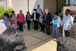 Opponents of a grain elevator proposed along the Mississippi River pray outside a courthouse in Edgard, La., April 28, 2022.