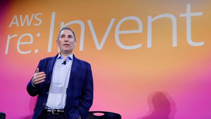 In this Dec. 5, 2019, file photo, AWS CEO Andy Jassy, discusses a new initiative with the NFL during AWS re:Invent 2019 in Las Vegas. In his first letter to Amazon shareholders, Jassy offered a defense of wages and benefits the company gives its warehouse workers while also vowing to improve injury rates inside the facilities. Jassy, who took over from Amazon founder Jeff Bezos as CEO last July, wrote the company has researched and created a list of the top 100 “employee experience pain points” and is working to solve them. A report released this week by a coalition of four labor unions found Amazon employed 33% of all U.S. warehouse workers in 2021, but was responsible for 49% of all injuries in the industry.
