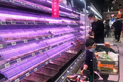Customers look through empty shelves at a supermarket in Shanghai, China, on March 30, 2022. Residents of Shanghai are struggling to get meat, rice and other food supplies under anti-coronavirus controls that confine most of its 25 million people in their homes, fueling frustration as the government tries to contain a spreading outbreak.