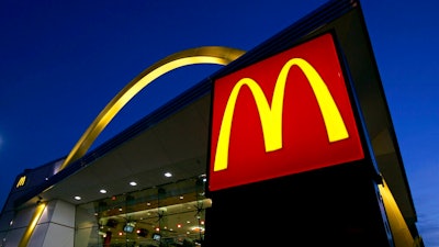 In this April 20, 2006 file photo, a McDonald's restaurant logo and golden arch is lit in Chicago'. McDonald’s investors will consider a proposal for a civil rights audit of the company after the federal government denied McDonald’s request to remove the proposal from the agenda at its annual meeting.