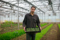 In this photo provided by the Rockefeller Foundation, Jason Grauer, the Seed and Crop Director at Stone Barns, poses for a photo at Stone Barns’s greenhouse on April 7, 2021, in Tarrytown, N.Y. Rockefeller grantee Stone Barns Center for Food and Agriculture is working on innovative, community-based ways to increase access to food and use sustainable environmental practices.
