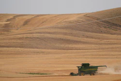 A combine harvests wheat near Pullman, Wash., Aug. 5, 2021.