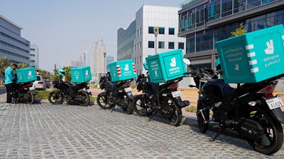 A delivery driver for the app Deliveroo prepares to make a delivery, in Dubai, Sept. 9, 2021.