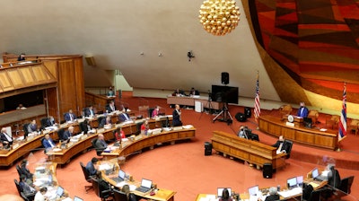 Members of the Hawaii House of Representatives discuss legislation at the State Capitol in Honolulu, May 3, 2022.