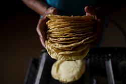 A worker packages tortillas to sell for 20 Mexican Pesos per kilogram — about one dollar — at a tortilla factory in Mexico City, May 9, 2022.