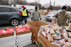 Sgt. Kevin Fowler organizes food at a food bank distribution by the Greater Cleveland Food Bank, Cleveland, Jan. 7, 2021.